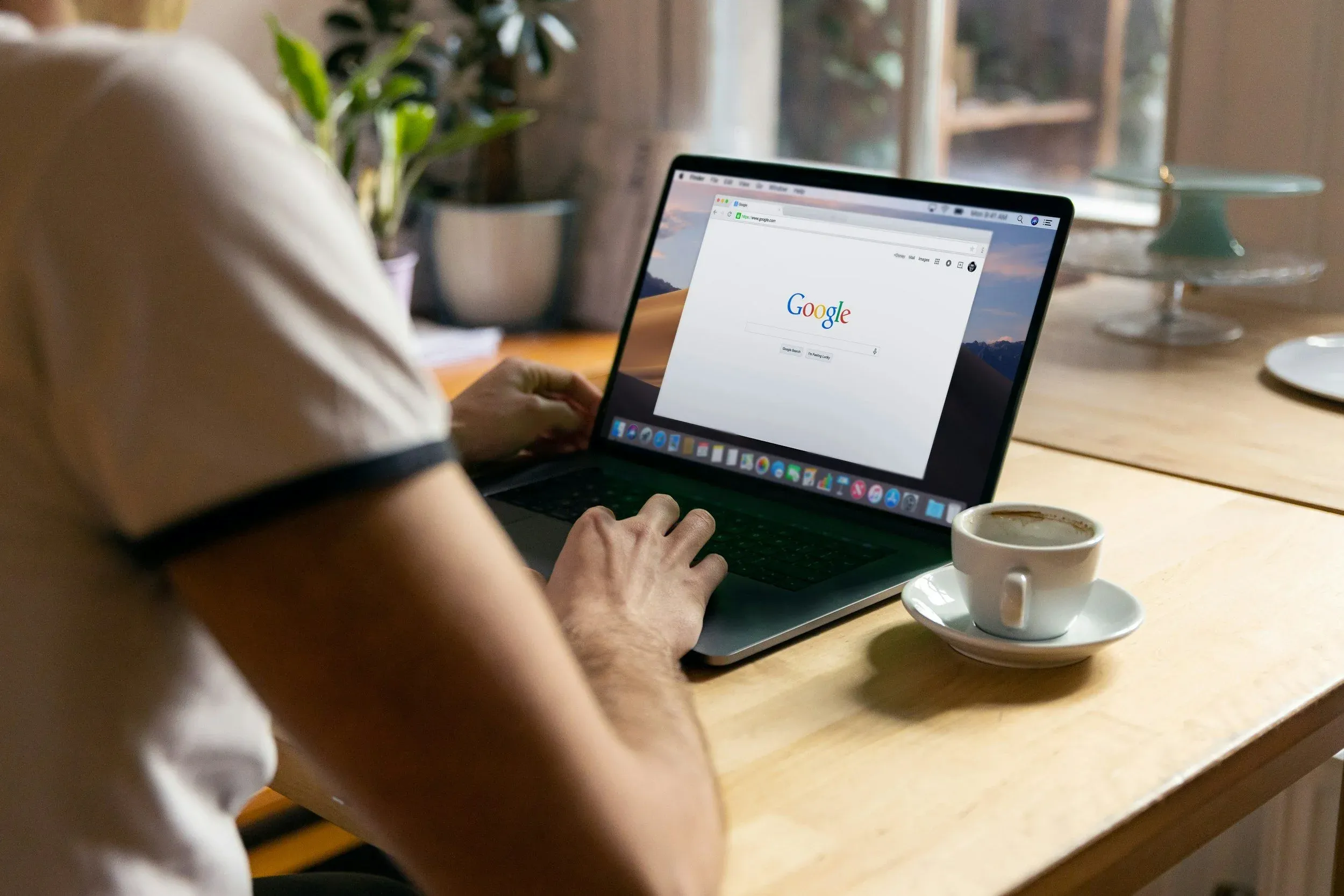 Person searching on Google from a laptop